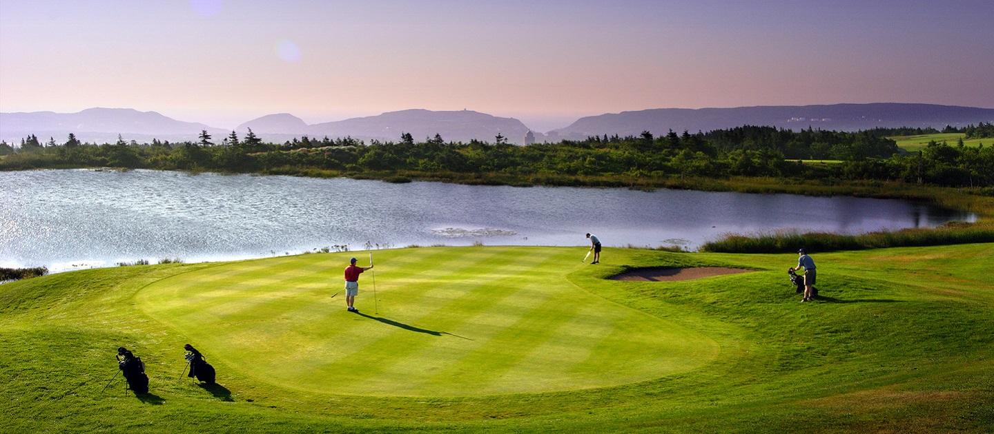 A golf course next to the water