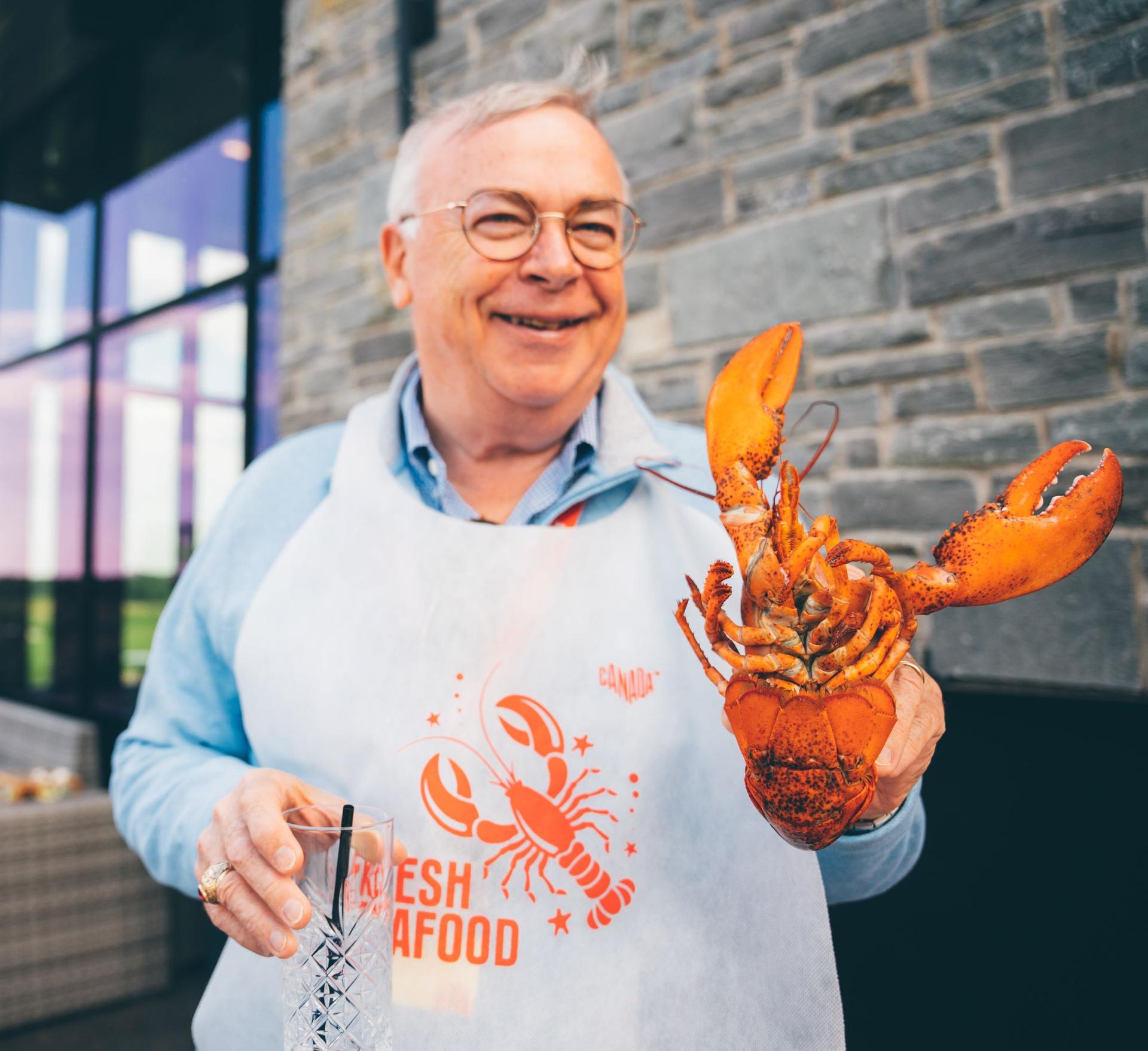 a person holding a lobster