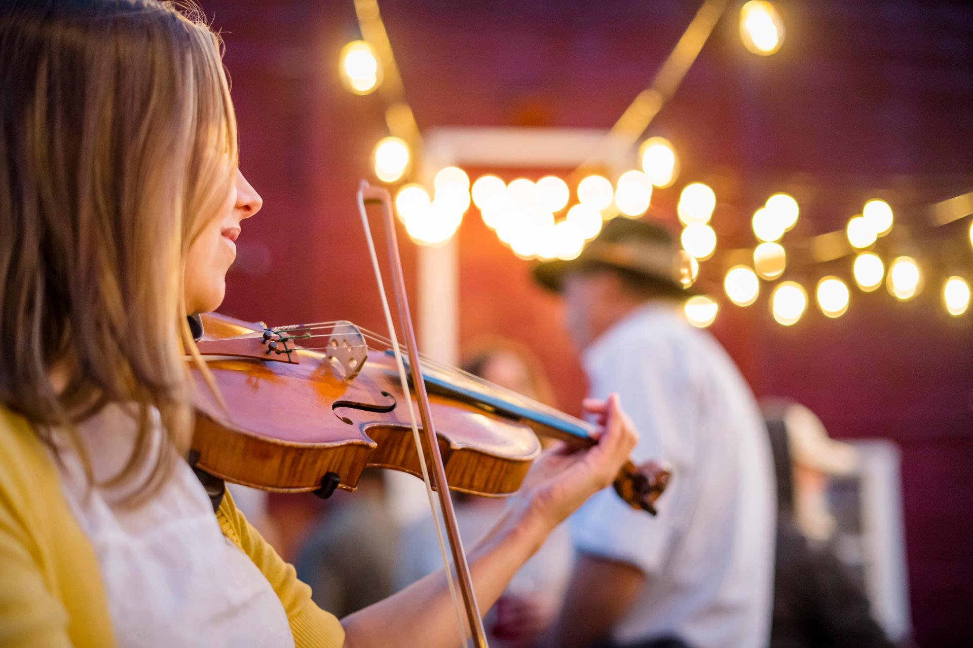 Bodrhan (Celtic drum) and fiddle musicians parade between pubs