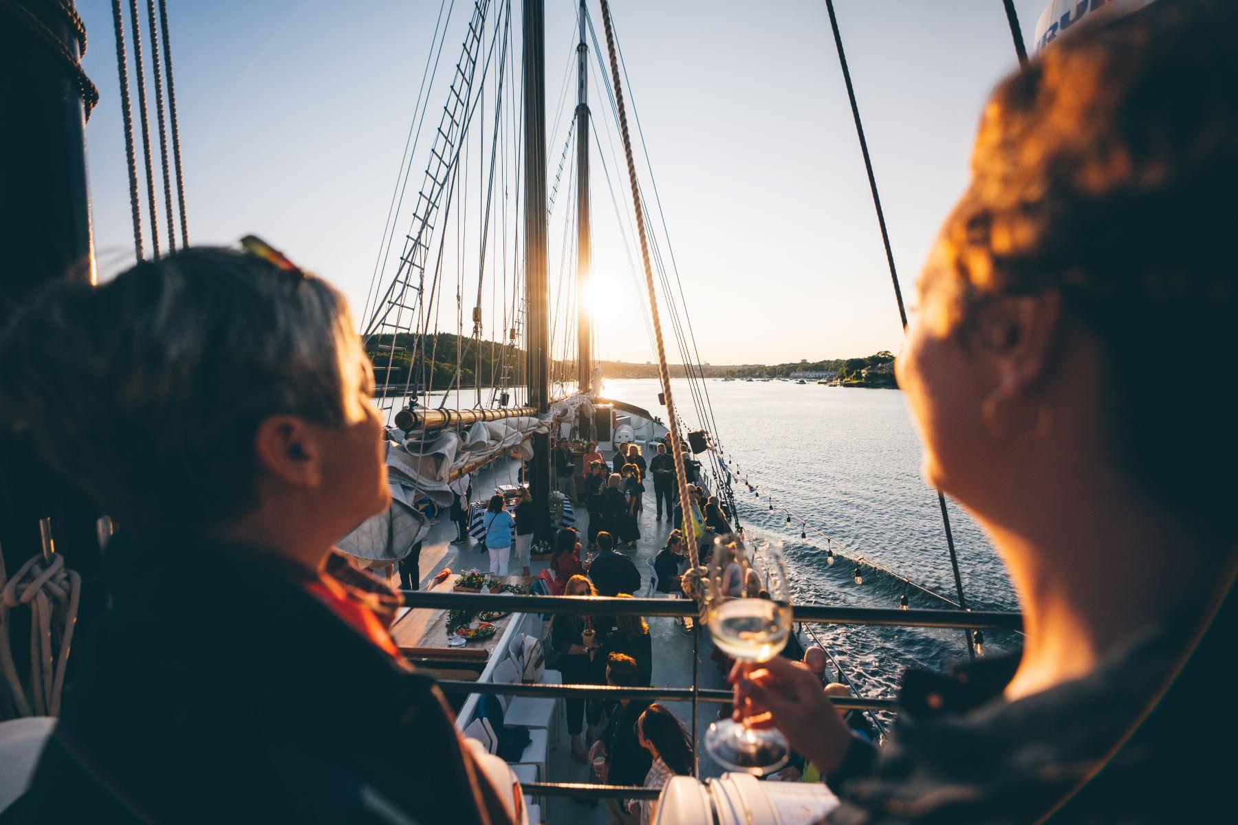 people gathering on a sailboat