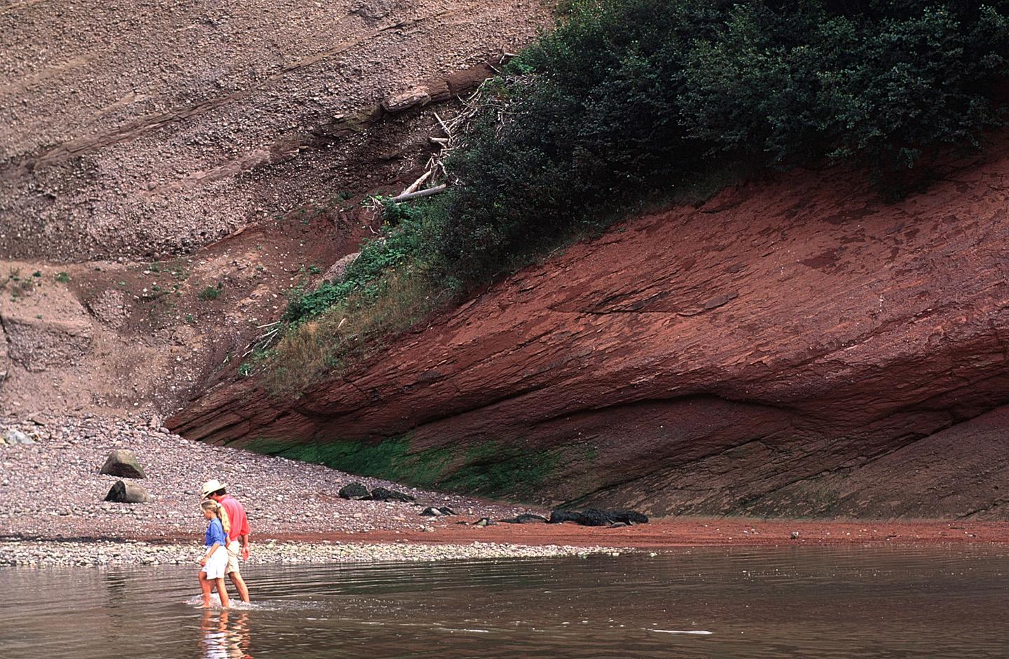 Beachcombing for fossils on a deserted red beach before tucking into a surfside picnic